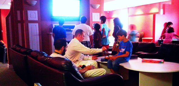 Zoltan playing Connect Four board game with Muslim student London Wednesday July 10 2013