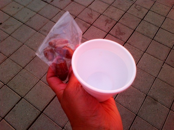 Ziploc bag of dates and styrofoam cup of water for Iftar outside TARIC Islamic Centre