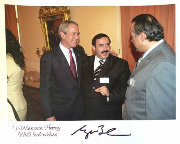 Former Syrian parliamentarian Mohamed-Mamon Alhomsi and former U.S. president George W. Bush in Prague in 2007. The photo, a gift from Bush to Alhomsi, is signed by Bush. Courtesy of Mohamed-Mamon Alhomsi.