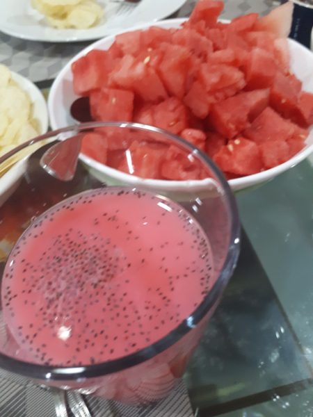 Sweet and aromatic drink made out of syrup , water & milk with basil seeds, watermelon in plate